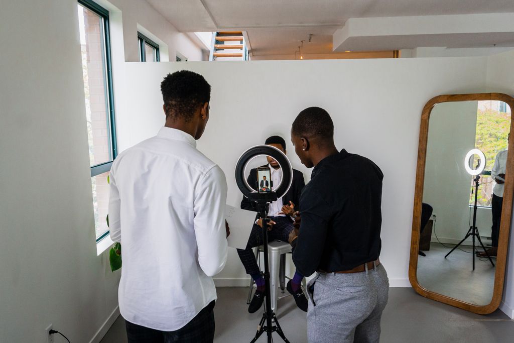 Men collaborating in a modern studio for a professional video shoot.